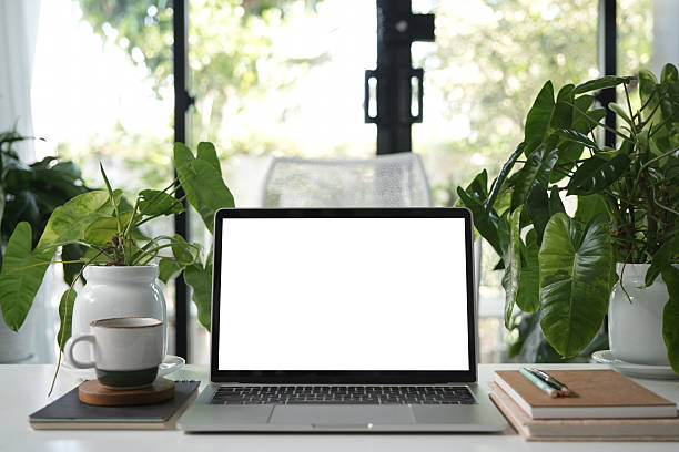 istock White screen Laptop and Vintage cup, cozy indoor workspace 2205098786