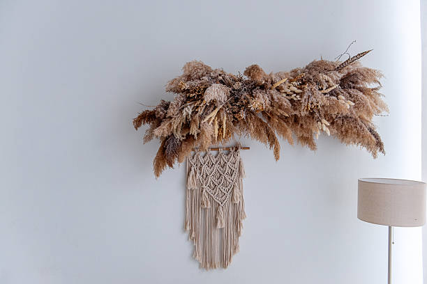 istock Dried flowers and macrame wall hanging creating cozy bohemian interior 2205099048