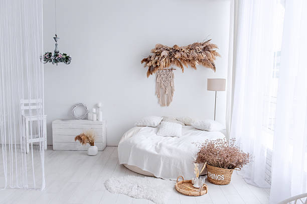 istock Round bed with macrame and dried plants creating cozy bohemian interior design 2205099746