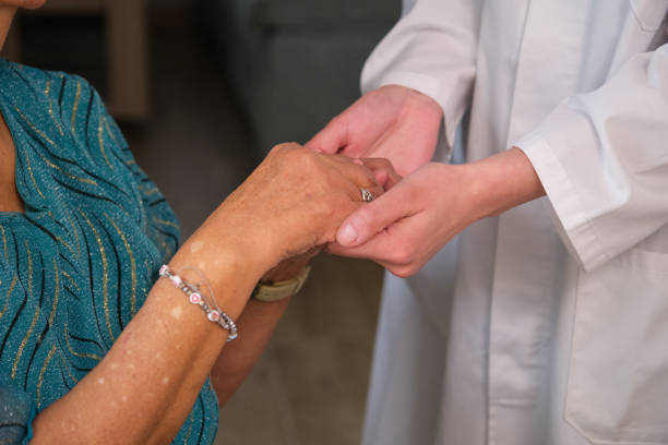 Doctor holding hand of a senior patient, showing empathy and care
