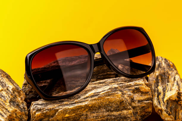 istock Trendy oversized sunglasses on textured rocks 2205102746