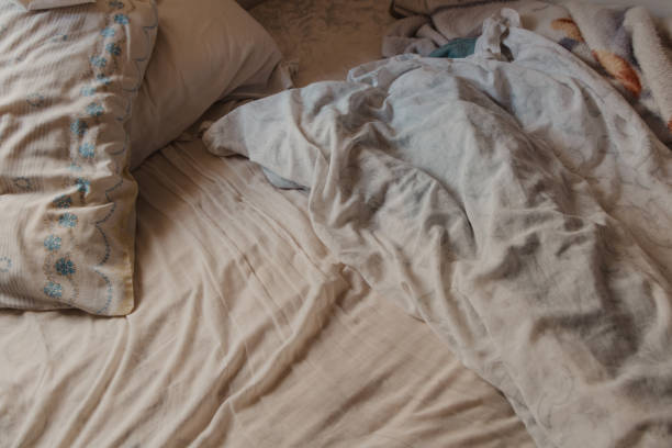 istock Cozy Bedroom Scene with Unmade Bed 2205103391