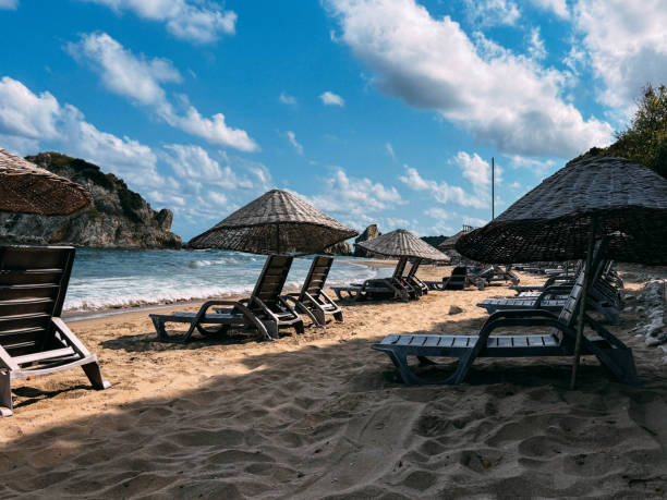 istock A tranquil beach scene featuring lounge chairs and umbrellas on golden sand under a bright blue sky. Sile, Turkey. Black Sea view 2205104767