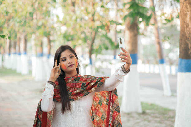 istock Young Woman Celebrating Holi with a Selfie 2205105871