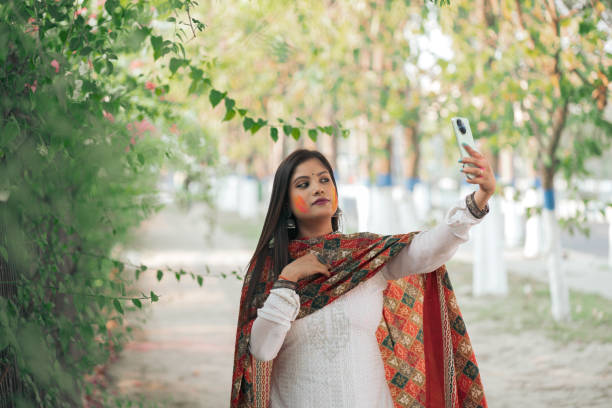 istock Young Woman Celebrating Holi with a Selfie 2205105924