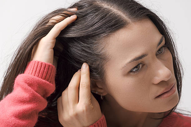 istock Young woman checking her hair 2205107769
