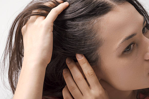 Young woman checking her hair