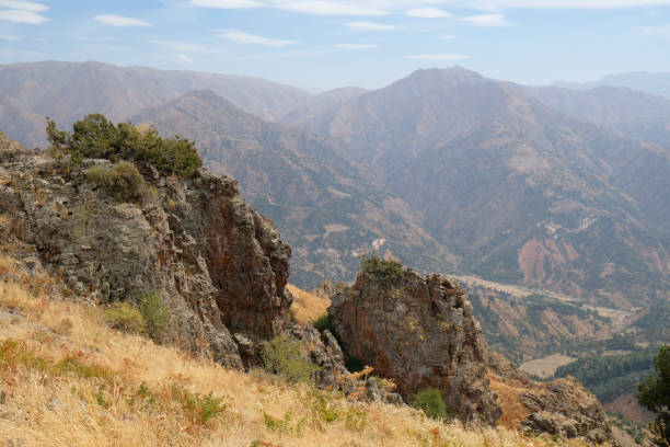 istock Stunning mountain landscape reveals rugged terrain and distant peaks under a clear sky 2205108047