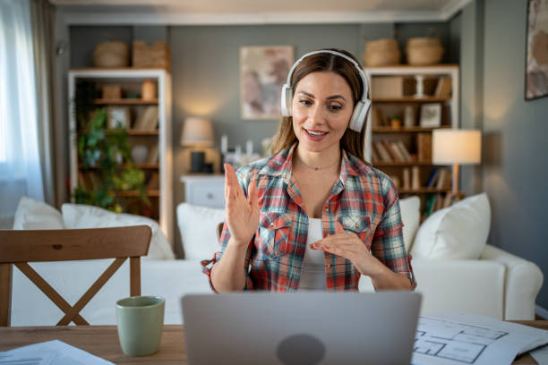 istock Architect wearing headphones making video call from home 2205111685