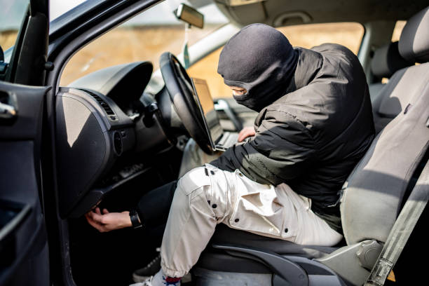 istock Masked Individual in Car Engaged in Suspicious Activity 2205113739