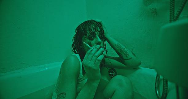istock Melancholic Bath Scene Illuminated in Green Light, Evoking Deep Emotional Contemplation 2205116271
