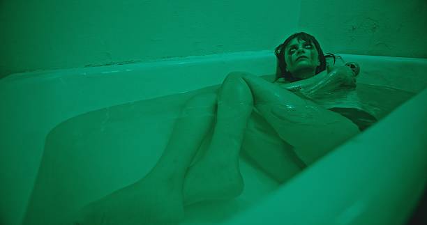 istock An Eerie Green Bathtub Scene Featuring a Troubled Subject and Capturing Complex Emotions 2205116333