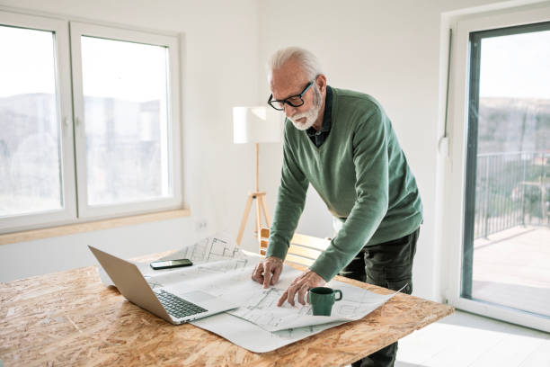 istock Portrait of an Architect Working on Blueprints in Office Studio 2205117311