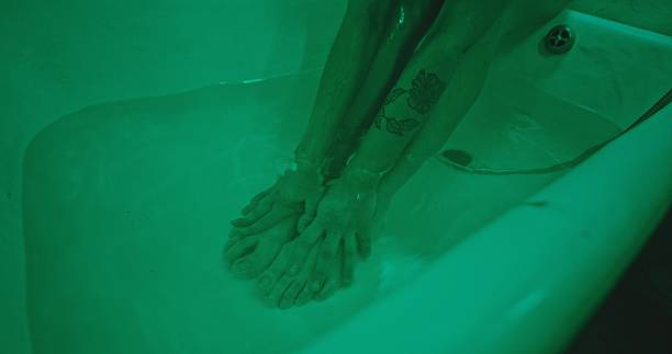 istock A person soaks their feet in soothing, greentinted water, creating a tranquil atmosphere 2205117436