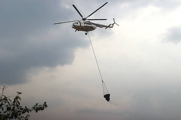 istock Waterbomb helicopters take water and transport it to extinguish forest fires 2205118344