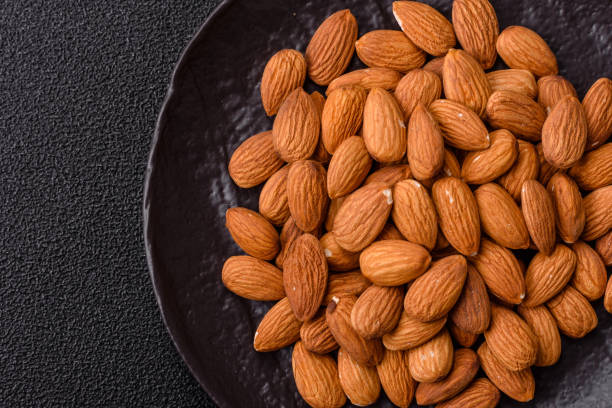 istock Roasted or raw peeled almonds in bowl 2205119951