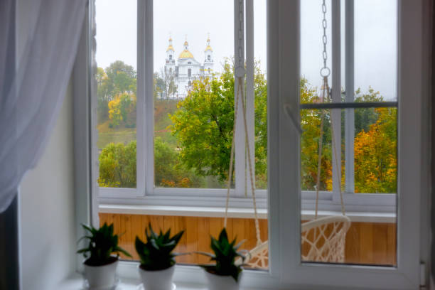 View from the window of the white-stone Assumption Cathedral. Autumn colors from the window of the house.