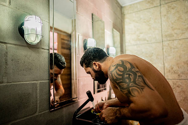 istock Mid adult man brushing teeth on bathroom at home 2205123088