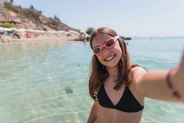 istock Girl taking a selfie with swimming goggles 2205123311