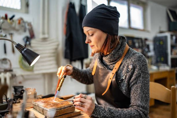 istock Female Artisan Using a Torch in Jewelry Studio Focused on Craftsmanship 2205123586