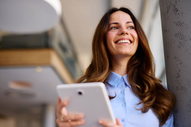 istock Smiling businesswoman using digital tablet in modern office 2205123603