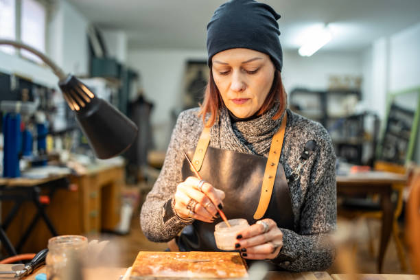 istock Female Artisan Working in a Craft Workshop Focused on Leatherworking 2205123668