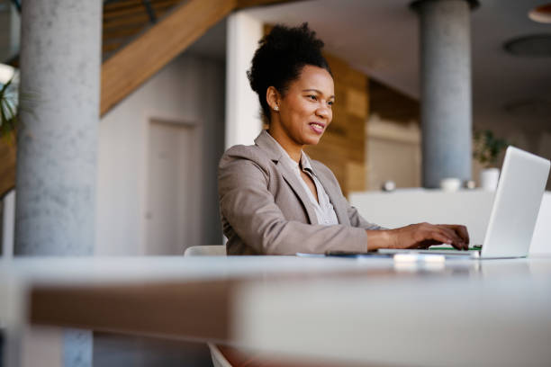 istock Businesswoman working on laptop in modern office space 2205123782