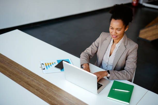 istock Confident businesswoman working on laptop in modern office 2205123790