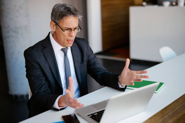 istock Stressed businessman having a video call in the office 2205123839