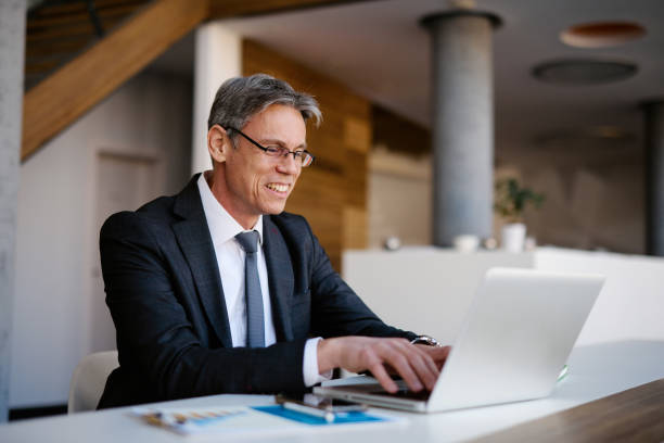 istock Businessman working on laptop in modern office 2205123844