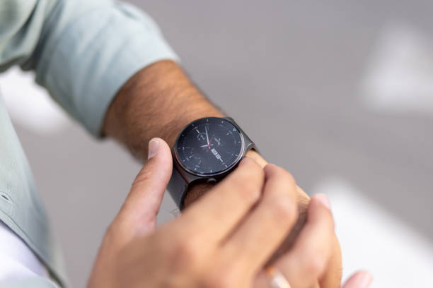 istock Businessman checking time on smartwatch during busy day 2205124134