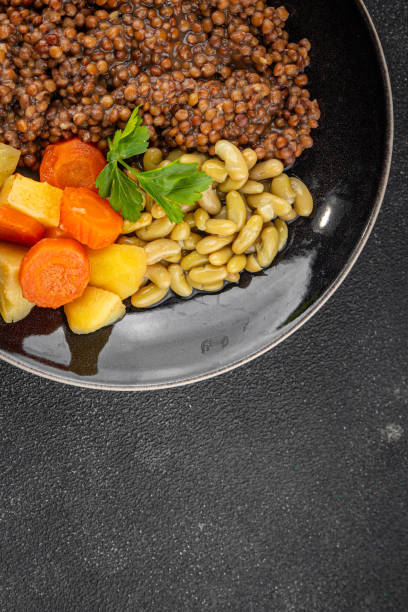 Vegetarian main course vegetables lentils, beans, potatoes, carrots tasty fresh delicious gourmet food background on the table rustic food top view copy space keto and paleo diet vegetarian and vegan food