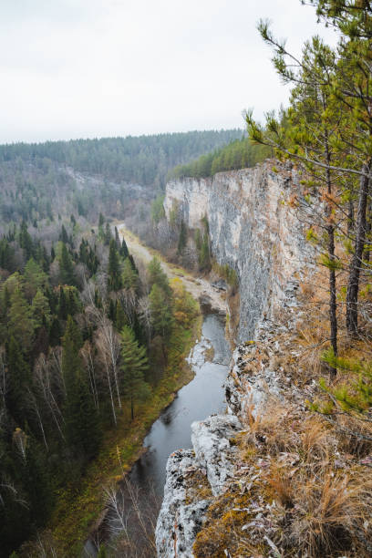 istock A beautiful river gracefully flows through a picturesque valley that is surrounded by lush trees nestled against a rugged rocky cliff, creating a stunning natural landscape 2205126788