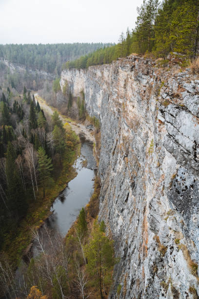 istock A serene river is gracefully flowing through a picturesque valley, beautifully nestled between two majestic cliffs that are lushly surrounded by vibrant trees and rich greenery all around 2205126800