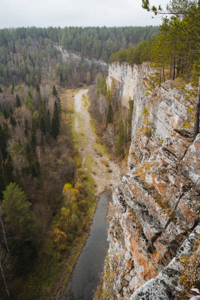 istock A beautiful river gently flows through a picturesque valley, nestled between two towering, rugged rocky cliffs that rise dramatically on either side of the serene waterway 2205126808