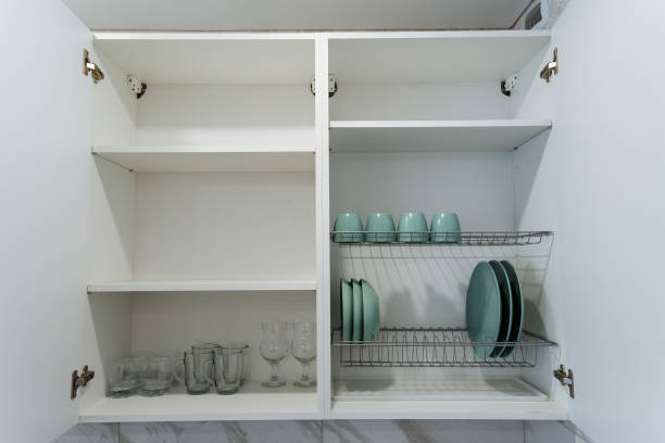 istock In the kitchen, there is a cabinet that holds various items such as plates, cups, and glasses neatly arranged inside it, providing both functionality and organization to the space 2205126845