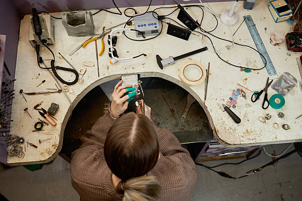 istock Overhead View of Person Working at Cluttered Workbench 2205128272