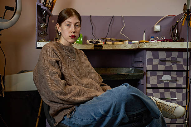 istock Portrait of Young Woman Sitting in Workshop Setting 2205128291