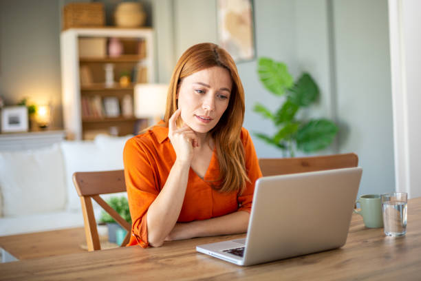 istock Woman reading on laptop 2205129580