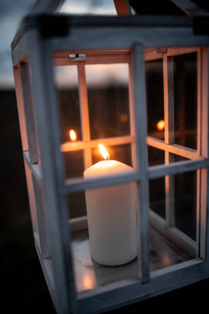 istock Close-up of a Candle in a Rustic Lantern with Glass Panes 2205132812