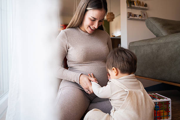 istock Son touching pregnant mother's belly 2205132926