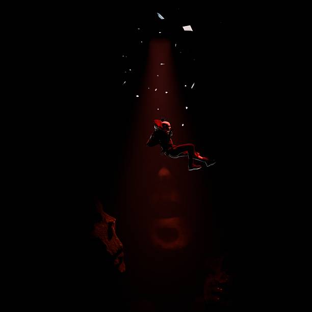 istock A 3D visualization of a man falling into an abyss, surrounded by giant zombie heads and skulls. 2205133547