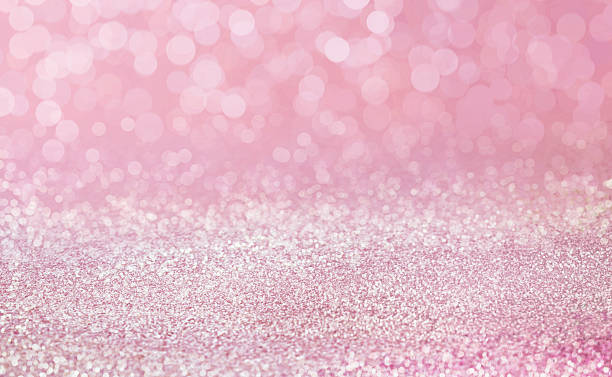 istock Pink sand on the floor with a shiny bokeh reflection backdrop. 2205133751