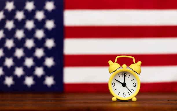 istock Alarm clock with American flag, US immigration office background 2205135187
