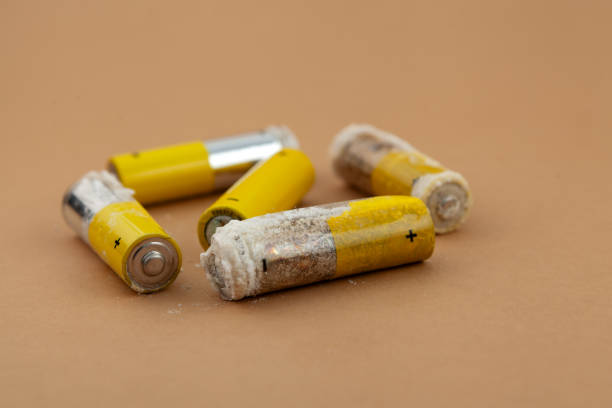 istock Defective expired batteries, selective focus. Oxidized and leaking alkaline batteries with formation of caustic white powder of potassium hydroxide. Problems of recycling electronic waste 2205137312
