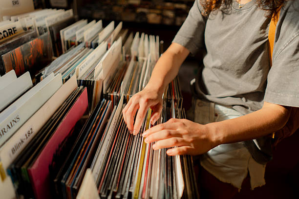 istock Woman going through records in record store 2205139671