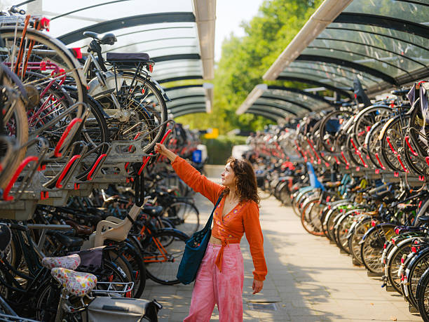 istock Woman getting her bicycle  from two level bicycle parking 2205139778