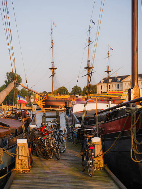 Old sailboats in harbour in Amsterdam  at sunset in summer