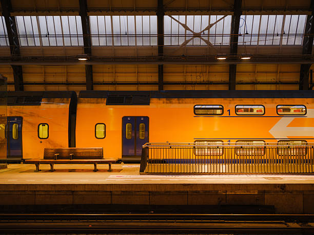 istock Yellow train on railway station in Amsterdam, Netherlands 2205139824