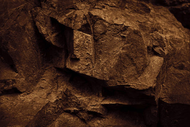 Black dark brown stone rock granite background. Mountain surface texture. Close-up. For design.